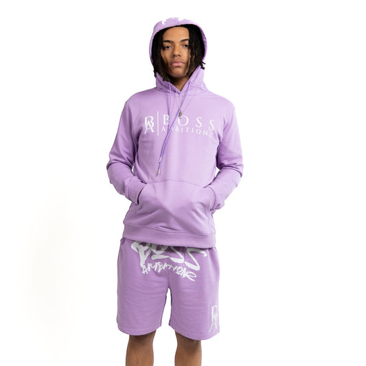 Commanding attention, the model showcases the Street Heat Purple Haze Tracksuit Set with a relaxed confidence. The lilac hoodie, emblazoned with the 'BOSS AMBITIONZ' logo, harmonizes with matching shorts featuring the statement 'AMBITIONZ' print. This coordinated set speaks to a laid-back yet fashion-forward street style.