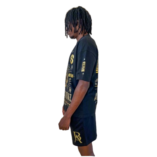 Side profile of DaKidswagg modeling Boss Ambitionz outfit: "Side profile of DaKidswagg modeling a black Boss Ambitionz t-shirt and shorts, showcasing the detailed gold text and logo designs