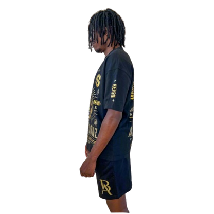 Side profile of DaKidswagg modeling Boss Ambitionz outfit: "Side profile of DaKidswagg modeling a black Boss Ambitionz t-shirt and shorts, showcasing the detailed gold text and logo designs