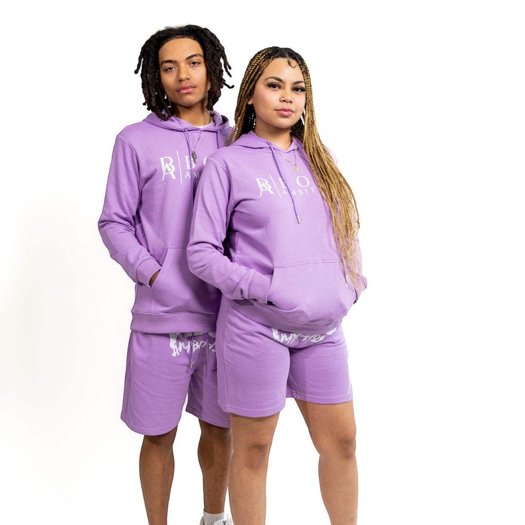 Paired to perfection, these two models embody the spirit of streetwear in the Street Heat Purple Haze Tracksuit Set. Their coordinated outfits, featuring the 'BOSS AMBITIONZ' logo on the hoodie and 'AMBITIONZ' on the shorts, showcase a unisex design that's both versatile and on-trend, making a strong statement about individuality and style