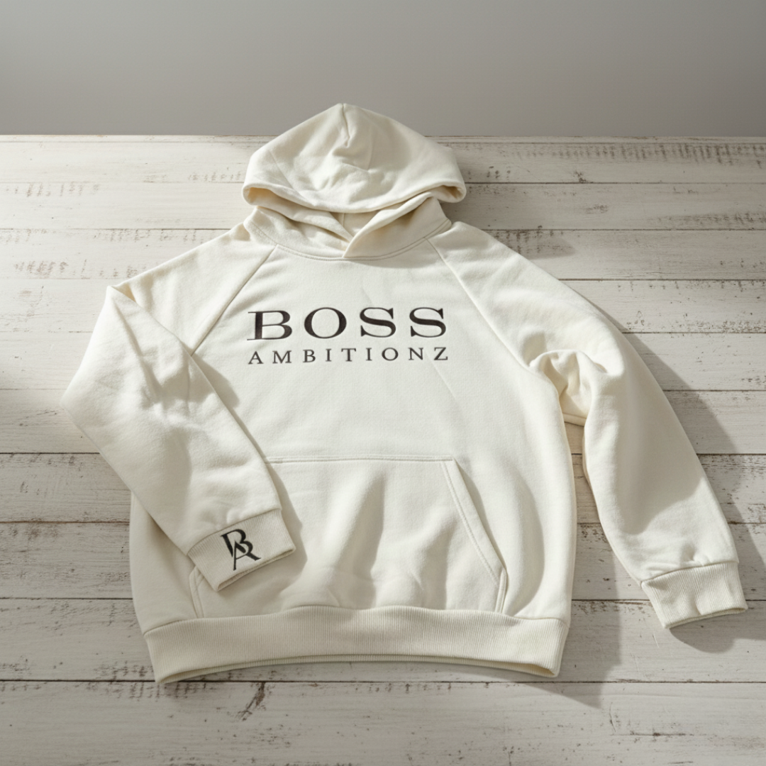 Cream hoodie with 'BOSS AMBITIONZ' text on a wooden surface