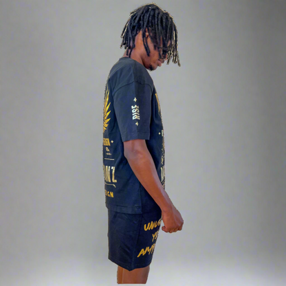Side profile of model in Boss Ambitionz outfit: "Side profile of model wearing Boss Ambitionz t-shirt and shorts, emphasizing the intricate gold designs and motivational text 'Unleash Your Ambition' on the shorts.