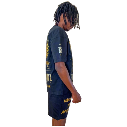 Side profile of model in Boss Ambitionz outfit: "Side profile of model wearing Boss Ambitionz t-shirt and shorts, emphasizing the intricate gold designs and motivational text 'Unleash Your Ambition' on the shorts.