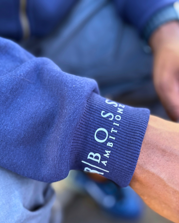 Close-up of a blue sleeve with 'BOSS AMBITION' branding.
