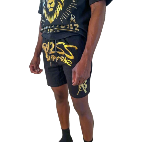 Close-up view of DaKidswagg in Boss Ambitionz shorts: "Close-up view of DaKidswagg wearing Boss Ambitionz shorts, highlighting the bold gold 'Boss Ambitionz' text and logo on the leg.