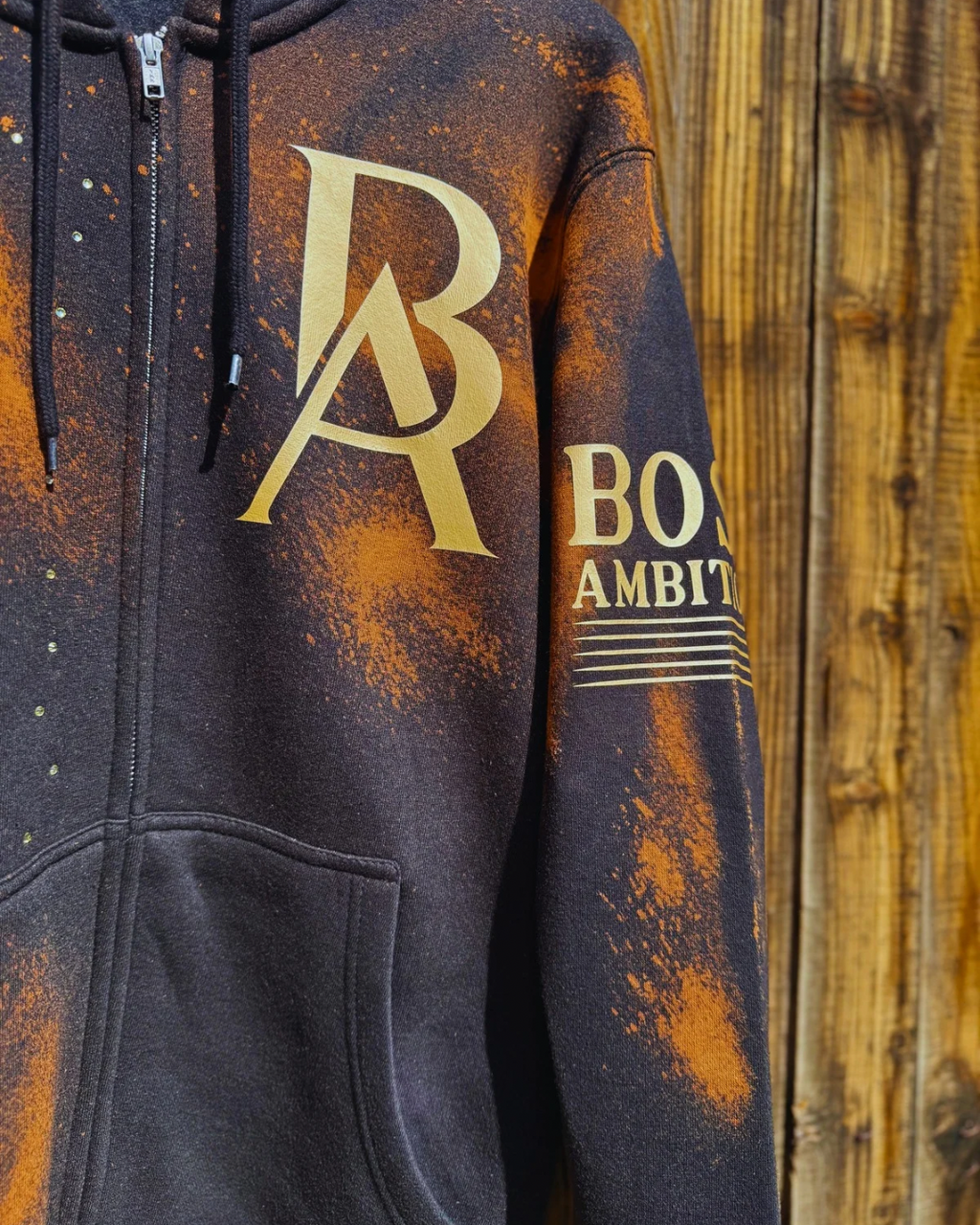 Hoodie with 'DB' and 'Boys Ambition' text on a wooden background