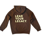 Product pic showcasing the back of the mocha and cream ultra heavyweight hoodie with the words LEAD YOUR LEGACY written boldly across the back. 