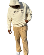 AveryBizMagent showcasing the Creme Burlee hoodie. Boss Ambitionz written across the chest with the letter BA on the right wrist. 