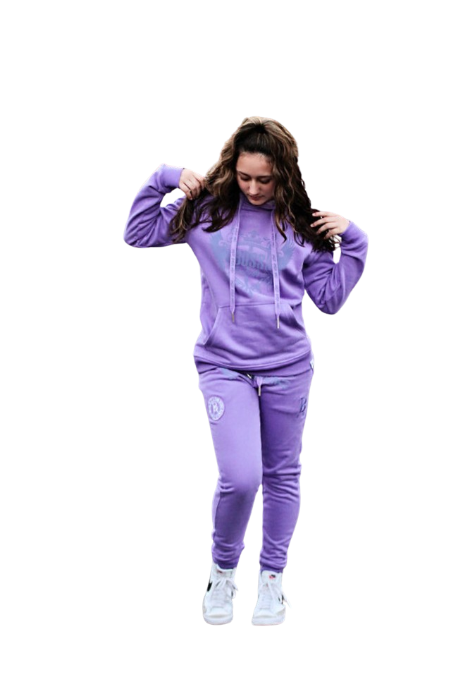 Rihanna posing in a powerful stance showcasing Boss Ambitionz Lavender Luxe Reflective Sweatsuit