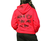 Rihanna showcasing the back of red Boss Ambitionz Ambition Crown Hoodie