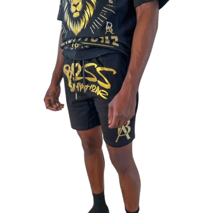 Close-up view of DaKidswagg in Boss Ambitionz shorts: "Close-up view of DaKidswagg wearing Boss Ambitionz shorts, highlighting the bold gold 'Boss Ambitionz' text and logo on the leg.